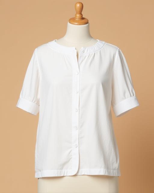 The 'Amelia' white linen blouse on a mannequin.